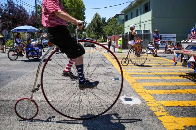 A man wears decorative socks while riding a vintage bicycle during  the 4th of July Parade in Alameda, California on Monday, July 4, 2016. (Photo by Gabrielle Lurie/AFP Photo)