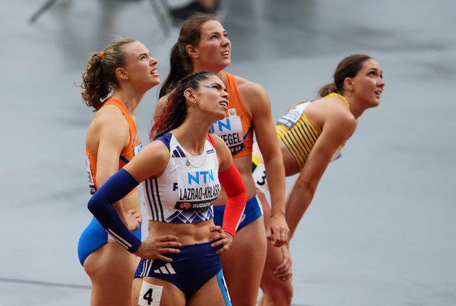 France's Auriana Lazraq-Khlass, Netherlands' Sofie Dokter and Emma Oosterwegel and Germany's Sophie Weissenberg react after the 100m hurdles heat during World Athletics Championship in Budapest, Hungary on August 19, 2023. (Photo by Aleksandra Szmigiel/Reuters)