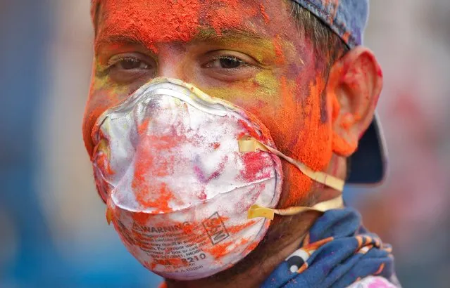 A man wearing protective mask attends Holi celebrations amid coronavirus precautions, in Chennai, India, March 10, 2020. (Photo by P. Ravikumar/Reuters)