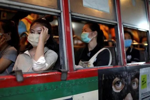 Women travel in a public bus wearing protective masks due to the coronavirus outbreak, in Bangkok, Thailand on March 9, 2020. (Photo by Jorge Silva/Reuters)