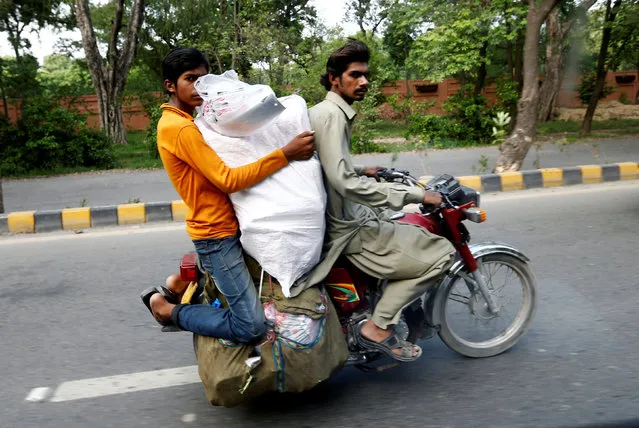 Men transport goods on a motorcycle on a street in Lahore, Pakistan July 11, 2016. (Photo by Caren Firouz/Reuters)