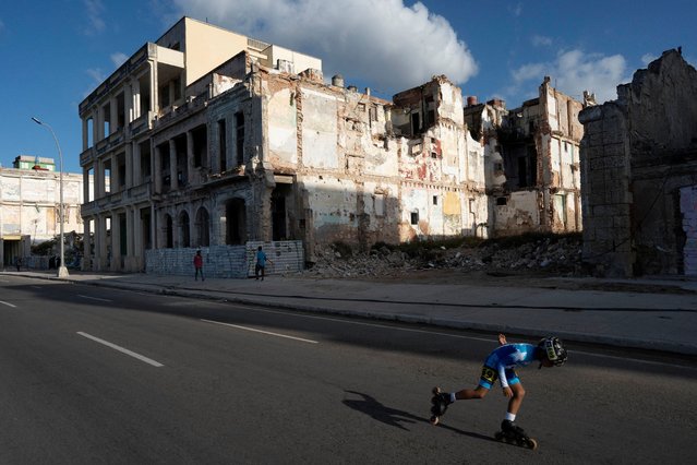 A child competes during the World Skate Marathon Tour along Havana's Malecon, Cuba on December 8, 2024. (Photo by Alexandre Meneghini/Reuters)
