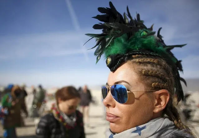 Nadina wears a feathered headdress during the Burning Man 2015 “Carnival of Mirrors” arts and music festival in the Black Rock Desert of Nevada September 5, 2015. (Photo by Jim Urquhart/Reuters)