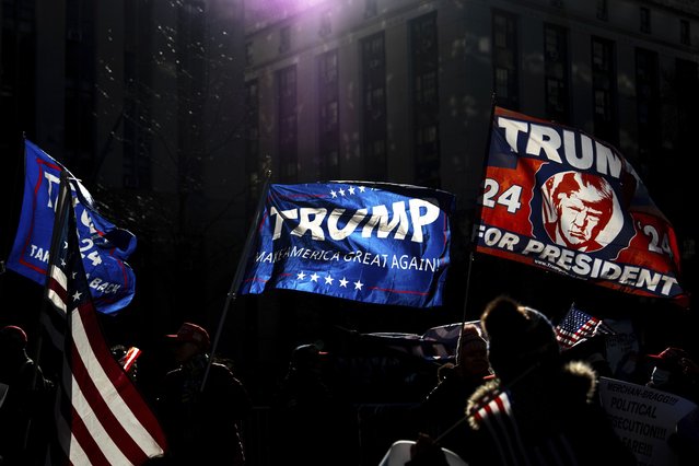 Demonstrators wave Trump flags outside Manhattan criminal court following the sentencing in President-elect Donald Trump's hush money case in New York, Friday, January 10, 2025. (Photo by Julia Demaree Nikhinson/AP Photo)