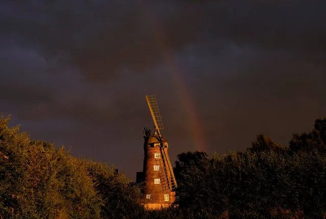 A rainbow forms over a windmill after rainfall in Shepshed, Britain, August 5, 2016. (Photo by Darren Staples/Reuters)