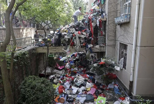 A pile of garbage is seen blocking an entrance to a residential building as workers clean up one of its apartments, in Qingdao, Shandong province, China, September 9, 2015. (Photo by Reuters/Stringer)