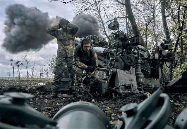 Ukrainian soldiers fire at Russian positions from a U.S.-supplied M777 howitzer in Ukraine's eastern Donetsk region Sunday, October 23, 2022. (Photo by LIBKOS/AP Photo)