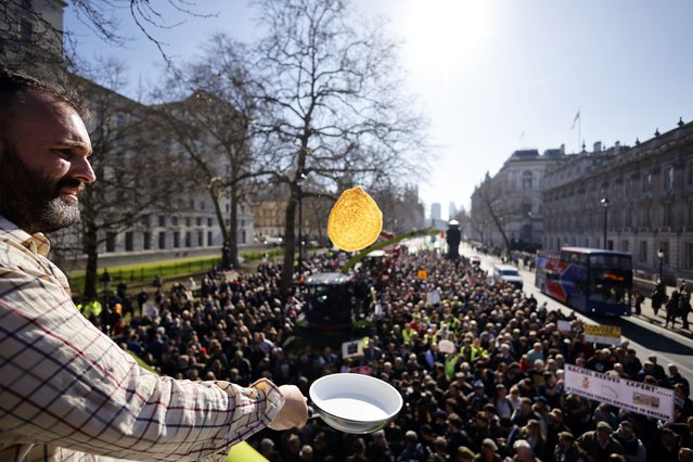 A protestor flips pancakes as British farmers take part in a “Pancake Day Rally” as they continue to campaign against inheritance tax in Westminster, London, Britain, 04 March 2025. British farmers are demanding a reversal of the changes to inheritance tax rules announced in the October 2024 budget by the Labour government, which will introduce new taxes on farms worth more than 1 million GBP that would apply from April 2026. (Photo by Tolga Akmen/EPA)