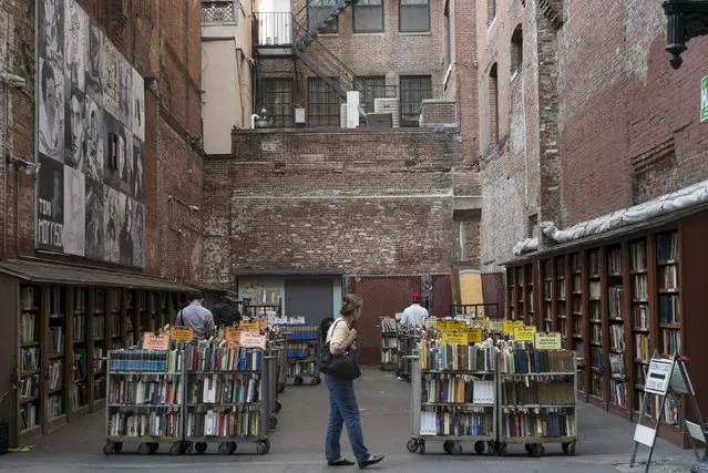Customers browse the used books for sale from the Brattle Book Shop in an alley in downtown Boston, Massachusetts September 1, 2015. (Photo by Brian Snyder/Reuters)