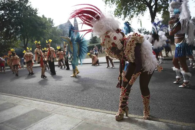 A performer adjusts her costume before participating in the parade at the Notting Hill Carnival in London, Britain August 29, 2016. (Photo by Neil Hall/Reuters)