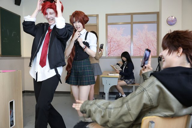 Visitors get their video recorded while wearing costumes at Chen Go, an “idol experience center” where fans dress up as K-Pop idols, in Shanghai, China, on April 5, 2025. (Photo by Go Nakamura/Reuters)
