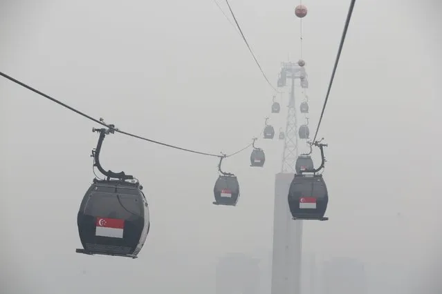 Cable cars moving towards the island resort of Sentosa are shrouded by haze in Singapore September 29, 2015. (Photo by Edgar Su/Reuters)