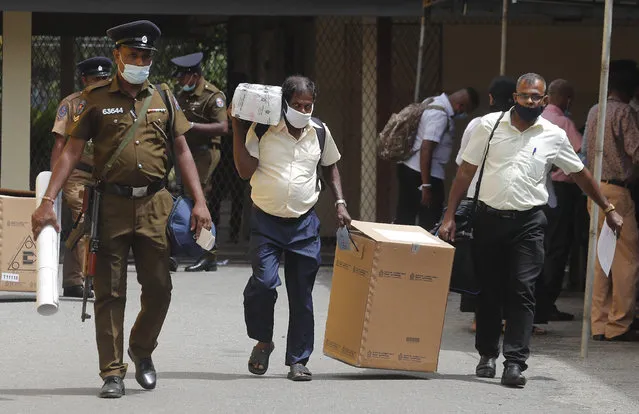 Sri Lankan polling officers dispatch election material to polling centers ahead of the parliamentary elections in Colombo, Sri Lanka, Tuesday, August 4, 2020. Sri Lankans are voting in parliamentary elections Wednesday that are expected to strengthen President Gotabaya Rajapaksa's grip on power. Parts of the party are also calling for a two-thirds majority in Parliament so it can amend the constitution to restore presidential powers curbed by a 2015 constitutional change. (Photo by Eranga Jayawardena/AP Photo)