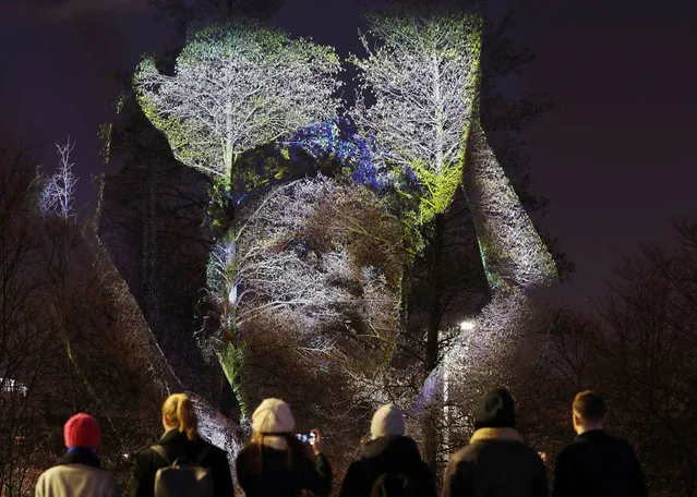 Londoners are being stopped in their tracks on the South Bank on January 25, 2018 by trees brought to life with awe-inspiring projections showing a community in the Sierra Leonean jungle that has been supported by WaterAid to get clean water and toilets. Trees on the South Bank are brought to life with projections of a community in the Sierra Leonean jungle that has been supported by a WaterAid appeal. Pictured is four-year-old Ibrahim from Tombohuaun with water collected from a dirty pond. (Photo by Oliver Dixon/Rex Features/Shutterstock)