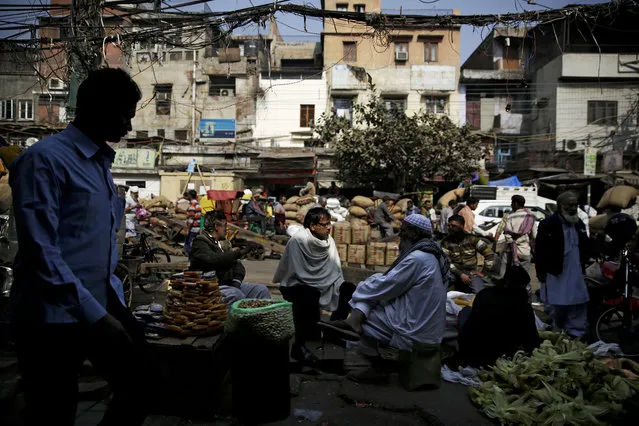 Roadside vendors wait for customers at a wholesale market in New Delhi, India, Thursday, February 1, 2018. India's finance minister Arun Jaitley on Thursday announced a federal budget with a string of populist giveaways, from affordable housing to a health plan for millions of the poor, in an attempt to woo voters ahead of national elections next year. (Photo by Altaf Qadri/AP Photo)