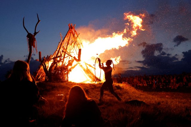 A fire dancer performs in front of the bonfire at the Bealtaine fire festival, marking the beginning of summer at the Hill of Uisneach in Rathnew, Ireland, on May 10, 2025. (Photo by Clodagh Kilcoyne/Reuters)