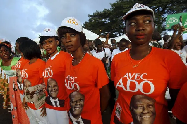 Supporters of Ivory Coast's President Alassane Ouattara and his party, the Rally of the Houphouetists for Democracy and Peace (RHDP), attend a campaign rally at the place inch alla in Abidjan October 20, 2015. Ouattara said on Monday he would push for constitutional reform if he wins re-election this week to scrap a nationality clause that helped drag his West African nation into a decade-long crisis. (Photo by Luc Gnago/Reuters)