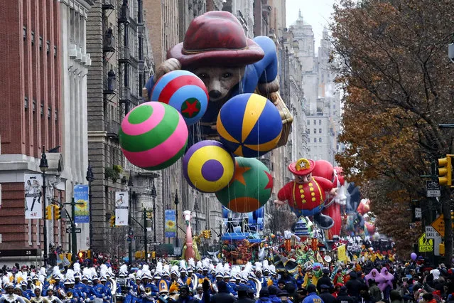 The 88th Annual Macy's Thanksgiving Day Parade travels Central Park West in New York on November 27, 2014. The giant balloons, a signature feature of the parade, made their debut in 1927. (Photo by Kena Betancur/AFP Photo)