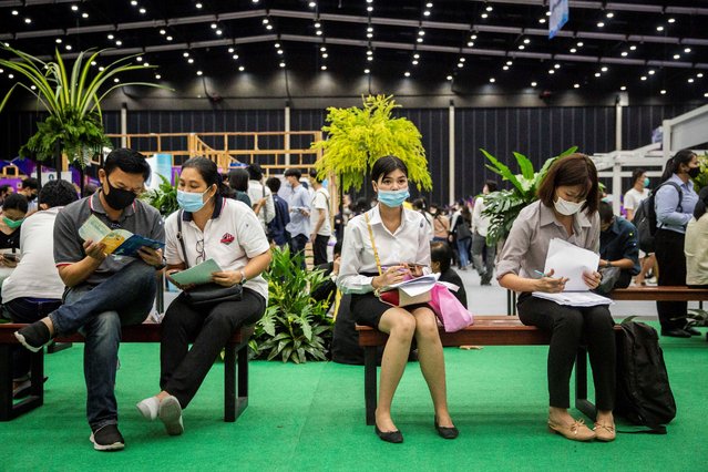 Prospective employees fill out applications at Job Expo Thailand on September 26, 2020 in Bangkok, Thailand. Thailand hosts Job Expo 2020, an effort by the Thai government and companies to boost the economy by offering nearly 1 million jobs to Thai people. Approximately 260,000 jobs are guaranteed to recent graduates while many other companies are focused on hiring elderly and disabled people. While Thailand has confirmed only two locally transmitted cases of COVID-19 in over three months, the economic impact of the virus has left millions unemployed. (Photo by Lauren DeCicca/Getty Images)