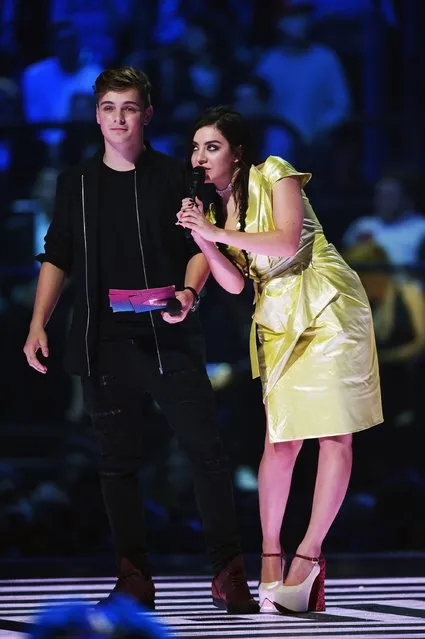 Charli XCX and Martin Garrix present on stage during the MTV EMA's 2015 at the Mediolanum Forum on October 25, 2015 in Milan, Italy. (Photo by Brian Rasic/Getty Images for MTV)