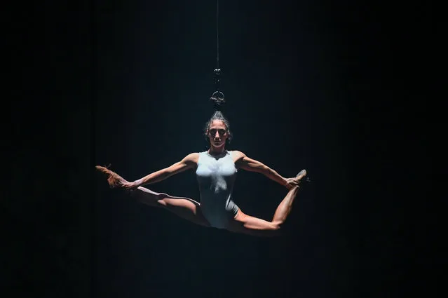 A members of the Hungarian circus dance company “Recirquel” hangs performing on the stage of the Budapest Arts' Palace (Muepa) in the frame of the CAFe (Budapest Contemporary Arts Festival) during the premiere of the show “Solus Amor”, directed by the Hungarian art director Bence Vagi, in Budapest, Hungary, on October 15, 2020. The Recirquel fuses contemporary circus with classical and modern dance creating “cirque dance”, a new language in the performing arts. (Photo by Attila Kisbenedek/AFP Photo)