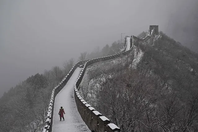 A woman visits the Great Wall in Mutianyu in the Huairou district, over 70km from Beijing on February 12, 2023.  (Photo by Hector Retamal/AFP Photo)