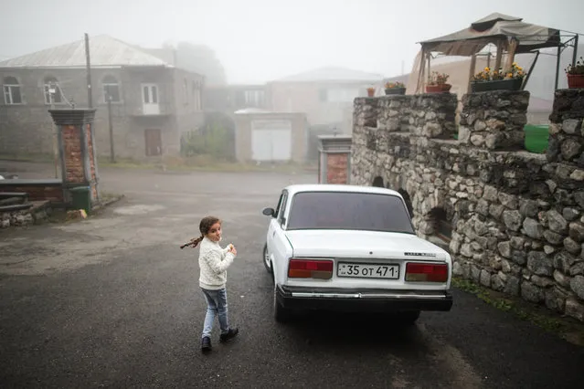A girl walks near a hotel where refugees from Nagorno-Karabakh are accommodated in Goris, Armenia on October 5, 2020. The situation in Nagorno-Karabakh escalated on September 27, 2020, with reports from Yerevan on the Azerbaijani troops advancing in the direction of Nagorno-Karabakh and shelling its settlements, including the capital city of Stepanakert. Both Azerbaijan and Armenia have declared martial law and military mobilization, reporting on casualties and injuries among civilians as well. (Photo by Sergei Bobylev/TASS)