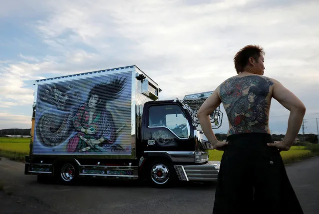 Truck driver Hideyuki Haga, 44, poses in front of his truck which is decorated with the same design as his tattoo on his back, in Hiki, Saitama, Japan, September 3, 2020. “When this painting was done I think I was about as excited as when my tattoo was done. The tattoo is now part of myself. I definitely feel proud of it”, said Haga. (Photo by Kim Kyung-Hoon/Reuters)