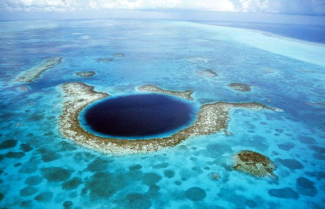 The Great Blue Hole in Belize – A large submarine sinkhole which is over 984 feet across and 407 feet deep. The sinkhole was formed during several episodes of quaternary glaciation when sea levels were much lower. (Photo by Kurt Amsler/Ardea/Caters News)