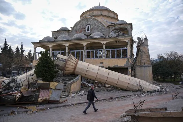 A man passes by a heavily damaged mosque on February 25, 2023 in Hatay, Turkey. A 7.8-magnitude earthquake hit near Gaziantep, Turkey, in the early hours of Monday February 6, followed by another 7.5-magnitude tremor just after midday. The quakes caused widespread destruction in southern Turkey and northern Syria and were felt in nearby countries. (Photo by Mehmet Kacmaz/Getty Images)