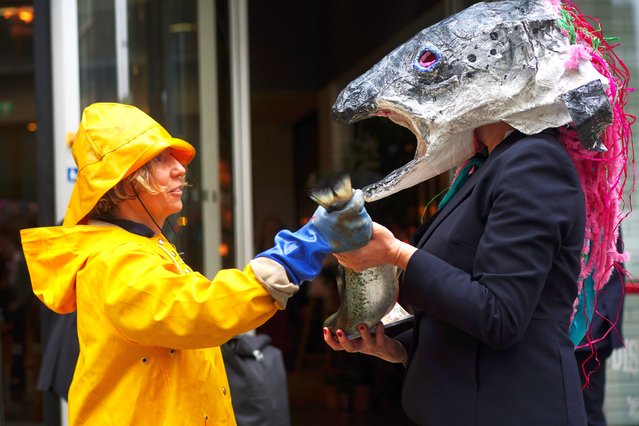 Campaigners from Ocean Rebellion take part in a protest outside the Hilton Hotel, central London on Tuesday, May 21, 2024, where the Blue Food Innovation Summit is taking place. (Photo by Victoria Jones/PA Images via Getty Images)
