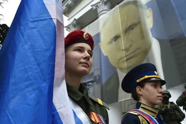Youth take part in an action to mark the ninth anniversary of the Crimea annexation from Ukraine in Yalta, Crimea, Friday, March 17, 2023. (Photo by AP Photo/Stringer)
