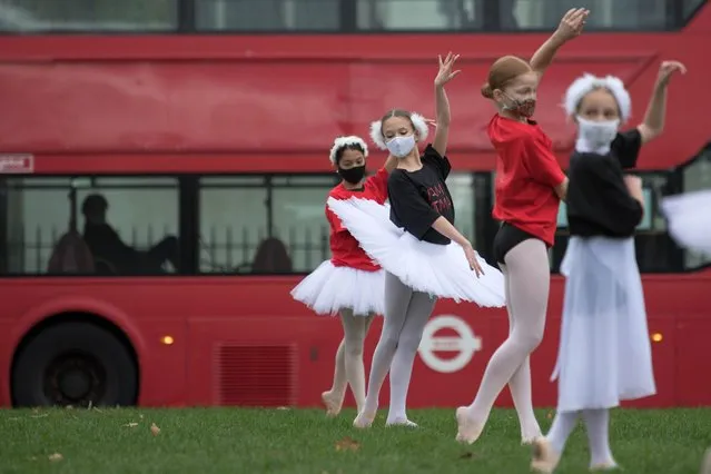 Young ballet dancers perform during a protest calling for more funding for the performing arts in Parliament Square, London on October 26, 2020. (Photo by Stefan Rousseau/PA Images via Getty Images)
