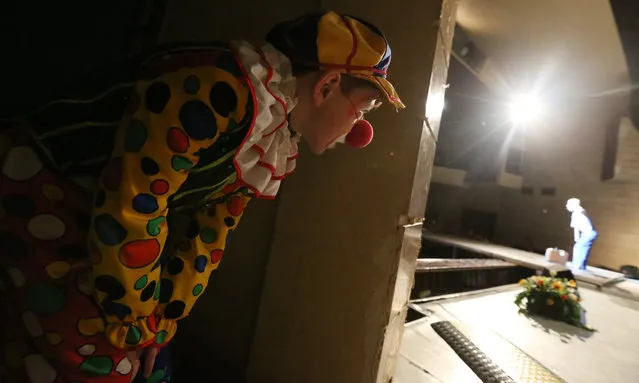 A clown watches from a backstage a performance of his colleague in the Arts Palace during the first clown festival in Belarus in Bobruisk, some 150 km from Minsk, Belarus, 01 April 2018. (Photo by Tatyana Zenkovich/EPA/EFE)