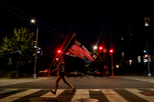A person runs with a flag as they take part in “cacerolazo”, a protest by Free DC that calls upon residents to bang pots and pans and make noise for five minutes at 8pm every night to protest the deployment of the National Guard and increased presence of federal law enforcement in Washington on September 8, 2025. (Photo by Daniel Becerril/Reuters)