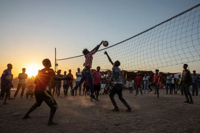 Tigray refugees who fled the conflict in Ethiopia's Tigray region, play volleyball at Um Rakuba refugee camp in Qadarif, eastern Sudan, Monday, November 23, 2020. Ethiopia's government is again warning residents of the besieged capital of the embattled Tigray region as the clock ticks on a 72-hour ultimatum before a military assault, saying “anything can happen”. (Photo by Nariman El-Mofty/AP Photo)