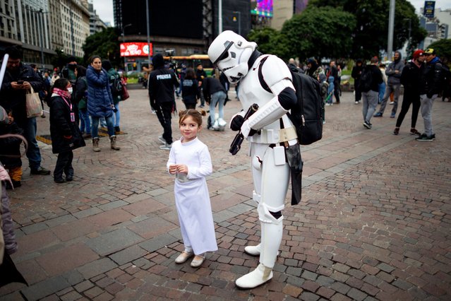 Fans of the Star Wars saga cosplaying as the characters Princess Leia (L) and a stormtrooper take part in the so-called “Meet From Another Galaxy” gathering in Buenos Aires on June 2, 2024. (Photo by Tomas Cuesta/AFP Photo)