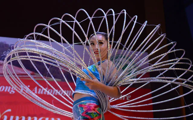 A Chinese artist takes part in a performance to celebrate the 40th anniversary of the establishment of diplomatic relations between China and Bangladesh, at North South University in Dhaka, Bangladesh on November 16, 2015. (Photo by Shariful Islam/Xinhua Press/Corbis)