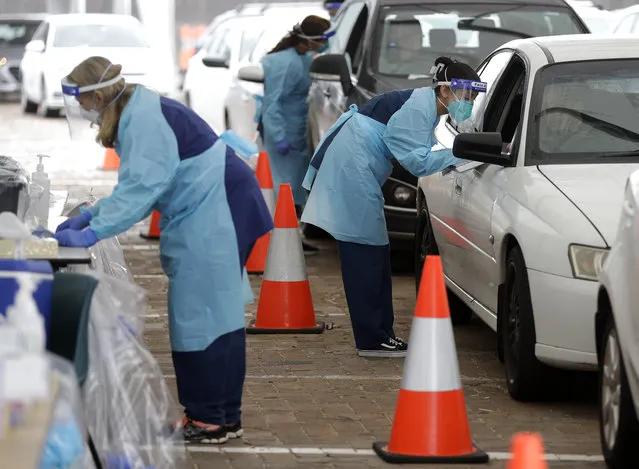People attend a drive through COVID-19 testing station at a beach in Sydney, Australia, Saturday, December 19, 2020. Sydney's northern beaches will enter a lockdown similar to the one imposed during the start of the COVID-19 pandemic in March as a cluster of cases in the area increased to more than 40. (Photo by Mark Baker/AP Photo)