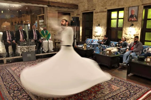 A whirling dervish performs at a restaurant during the Muslim holy month of Ramadan in Saida (Sidon) on April 1, 2023. (Photo by Joseph Eid/AFP Photo)