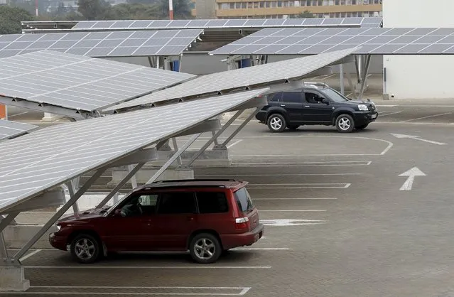 A car is seen parked under solar panels at a solar carport at the Garden City shopping mall in Kenya's capital Nairobi, September 15, 2015. (Photo by Thomas Mukoya/Reuters)