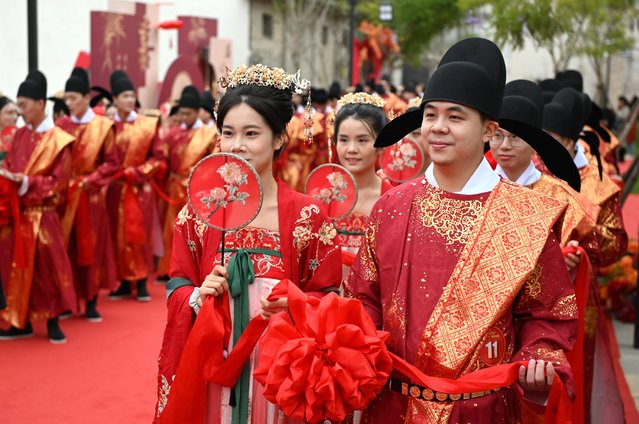 Newly-wed couples dressed in Tang-style costumes participate in a group wedding on October 28, 2025 in Fuzhou, Fujian Province of China. (Photo by Lyu Ming/China News Service/VCG via Getty Images)
