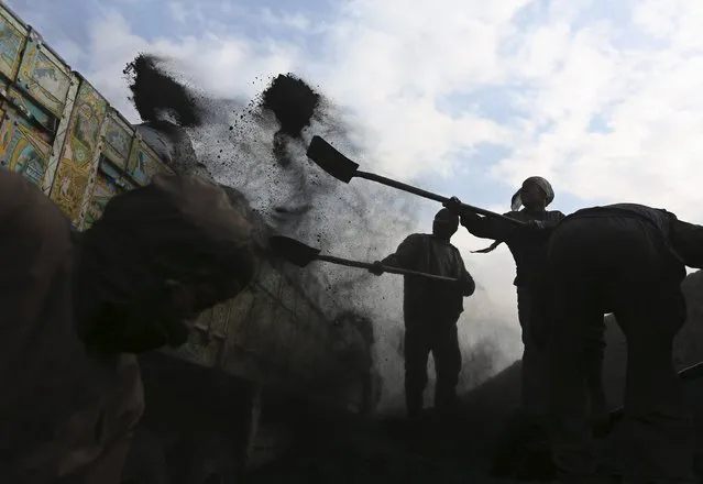 Labourers shovel coal onto a truck at a coal dump site outside Kabul in this January 23, 2014 file photo. (Photo by Omar Sobhani/Reuters)