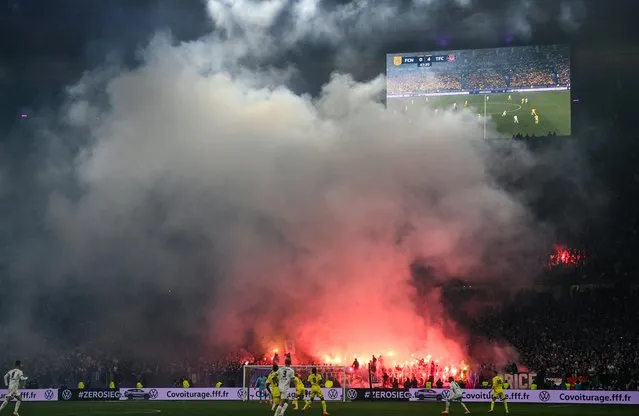 Toulouse's supporter lights flares during the French Cup final football match between Nantes (FC) and Toulouse (FC) at the Stade de France, in Saint-Denis, on the outskirts of Paris, on April 29, 2023. (Photo by Franck Fife/AFP Photo)