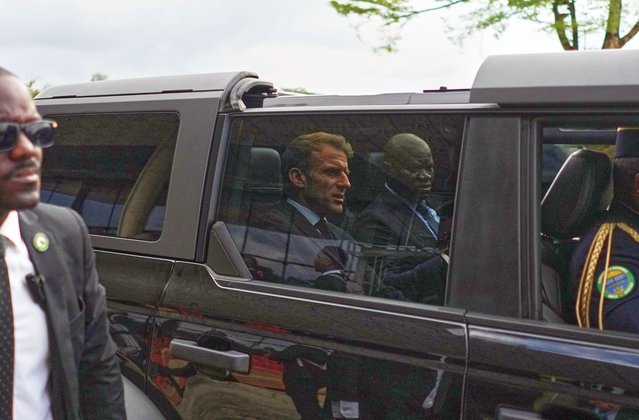 France's President Emmanuel Macron, left, and Gabon's President Brice Oligui Nguema, are seen as their motorcade drives past, in Libreville, Gabon, Monday, November 24, 2025. (Photo by Thibault Camus/AP Photo)