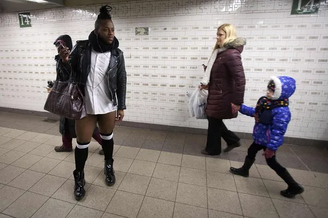 People look at a participant taking part in the “No Pants Subway Ride” in the Manhattan borough of New York January 11, 2015. (Photo by Carlo Allegri/Reuters)