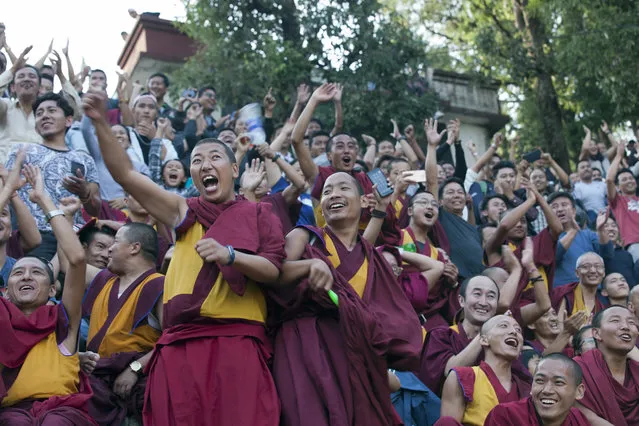 Exile Tibetan Buddhist monks cheer their team as they watch a soccer match in Dharmsala, India, Sunday, June 10, 2018. Soccer fans around the world are gearing up to watch the upcoming World Cup soccer tournament. (Photo by Ashwini Bhatia/AP Photo)