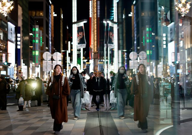 People walk through Ginza’s shopping district in Tokyo, Japan, 15 December 2025. Japan’s economic focus is on the upcoming Bank of Japan (BOJ) meeting where the central bank is expected to raise its policy rate to combat inflation. The BOJ signaled a rate hike bar is cleared with the wage momentum still intact. (Photo by Franck Robichon/EPA)