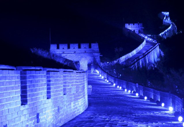 The Great Wall of China is lit up in blue to mark the 70th anniversary of the United Nations, in Beijing, China, October 24, 2015. (Photo by Li Sanxian/Reuters)