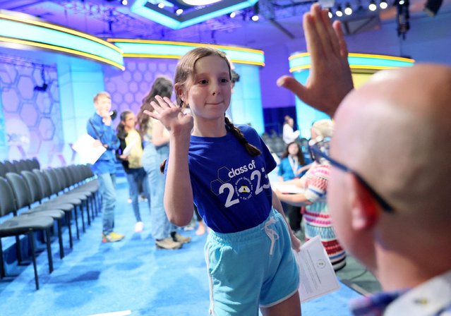 Dan Mervak high fives Clara Mervak, 11, to celebrate her advancement to the semifinals of the Scripps National Spelling Bee competition in National Harbor, Maryland U.S., May 31, 2023. (Photo by Leah Millis/Reuters)